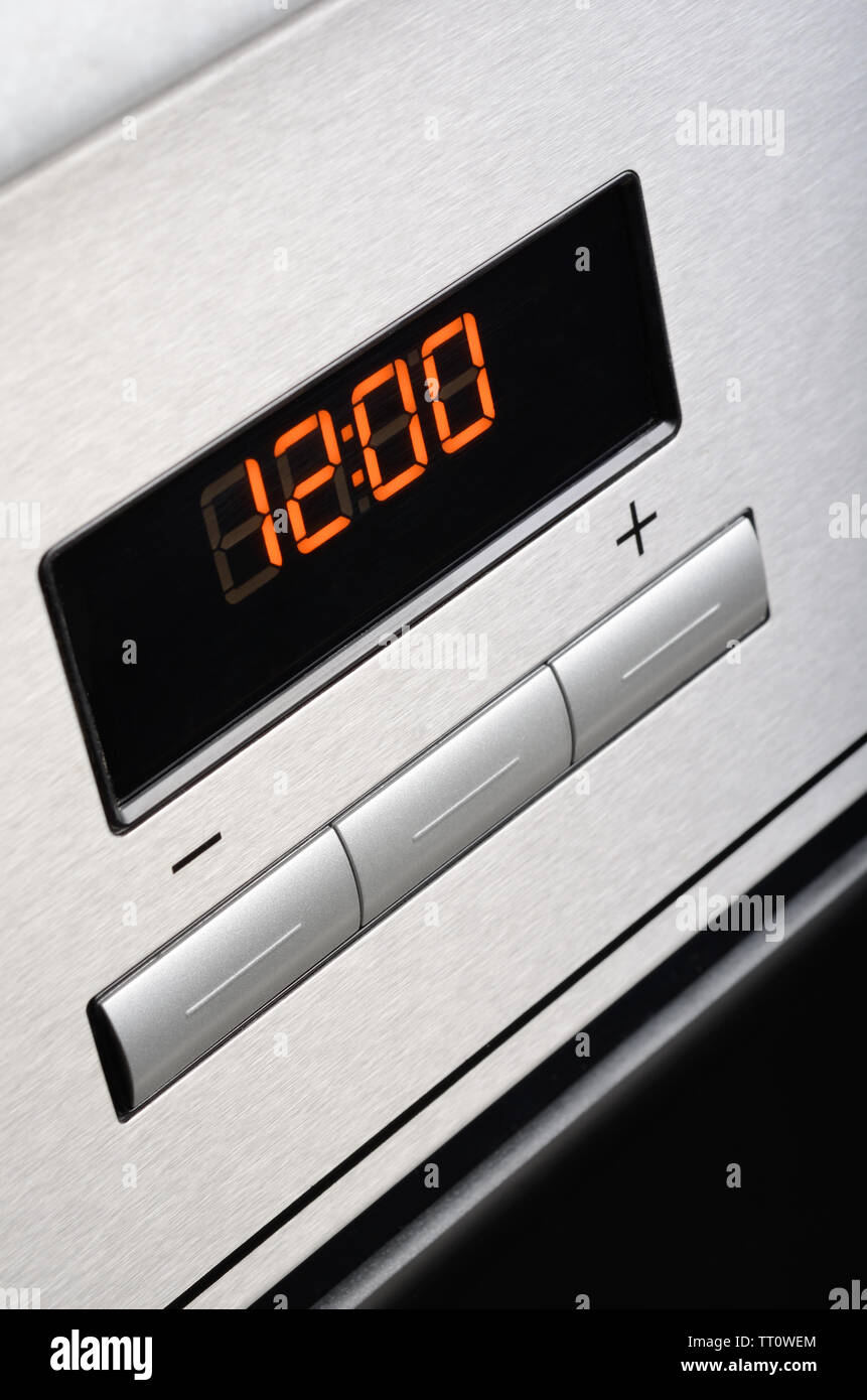 Digital timer of stainless steel oven. Macro shot. Stock Photo