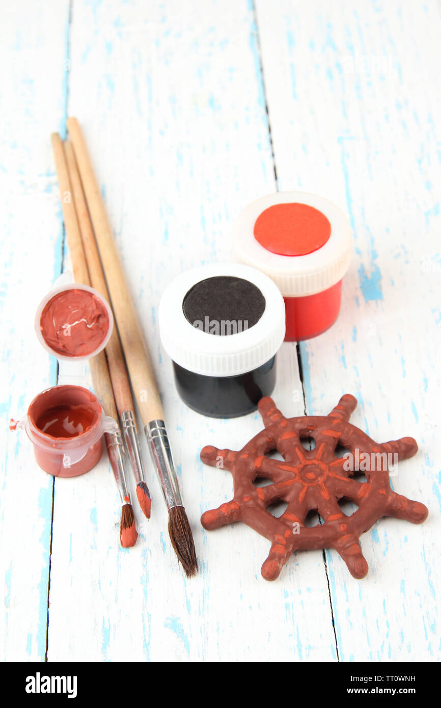 Hand made ceramic wheel and color paints on wooden table Stock Photo ...