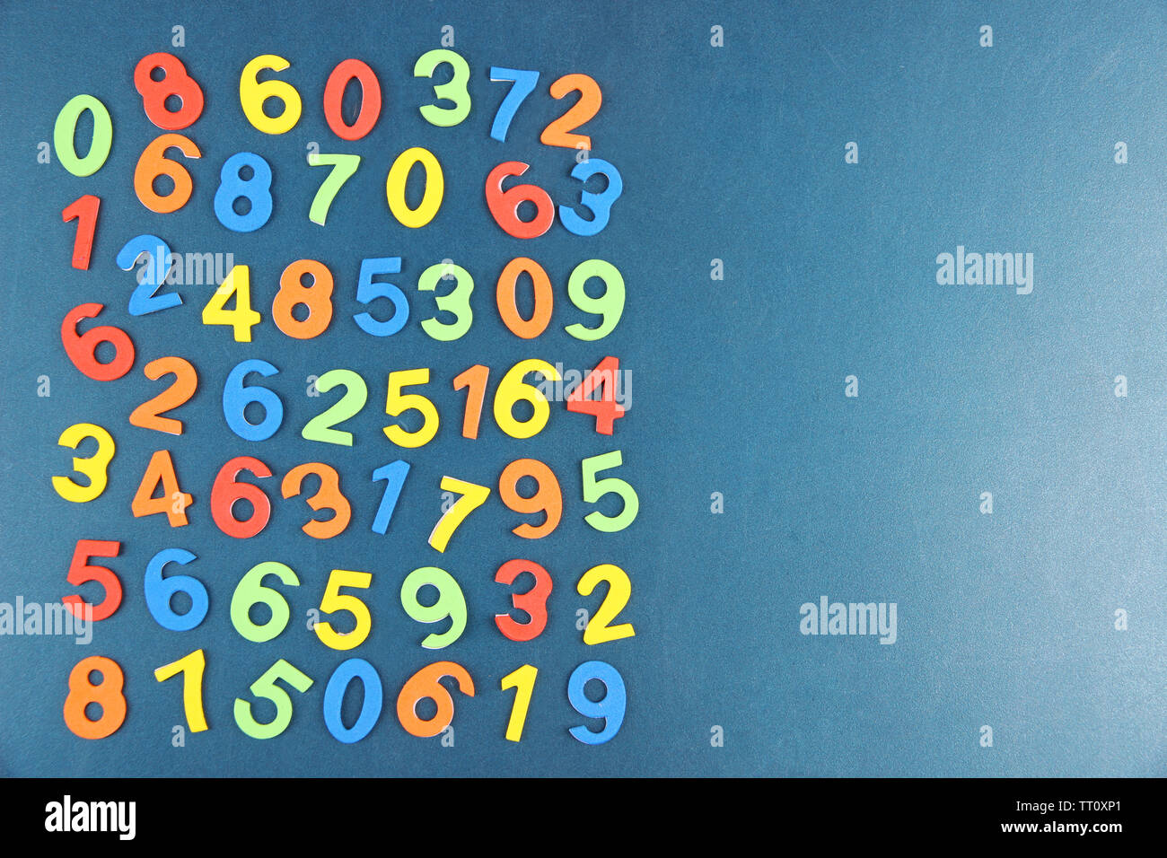Colorful numbers on school desk background Stock Photo - Alamy