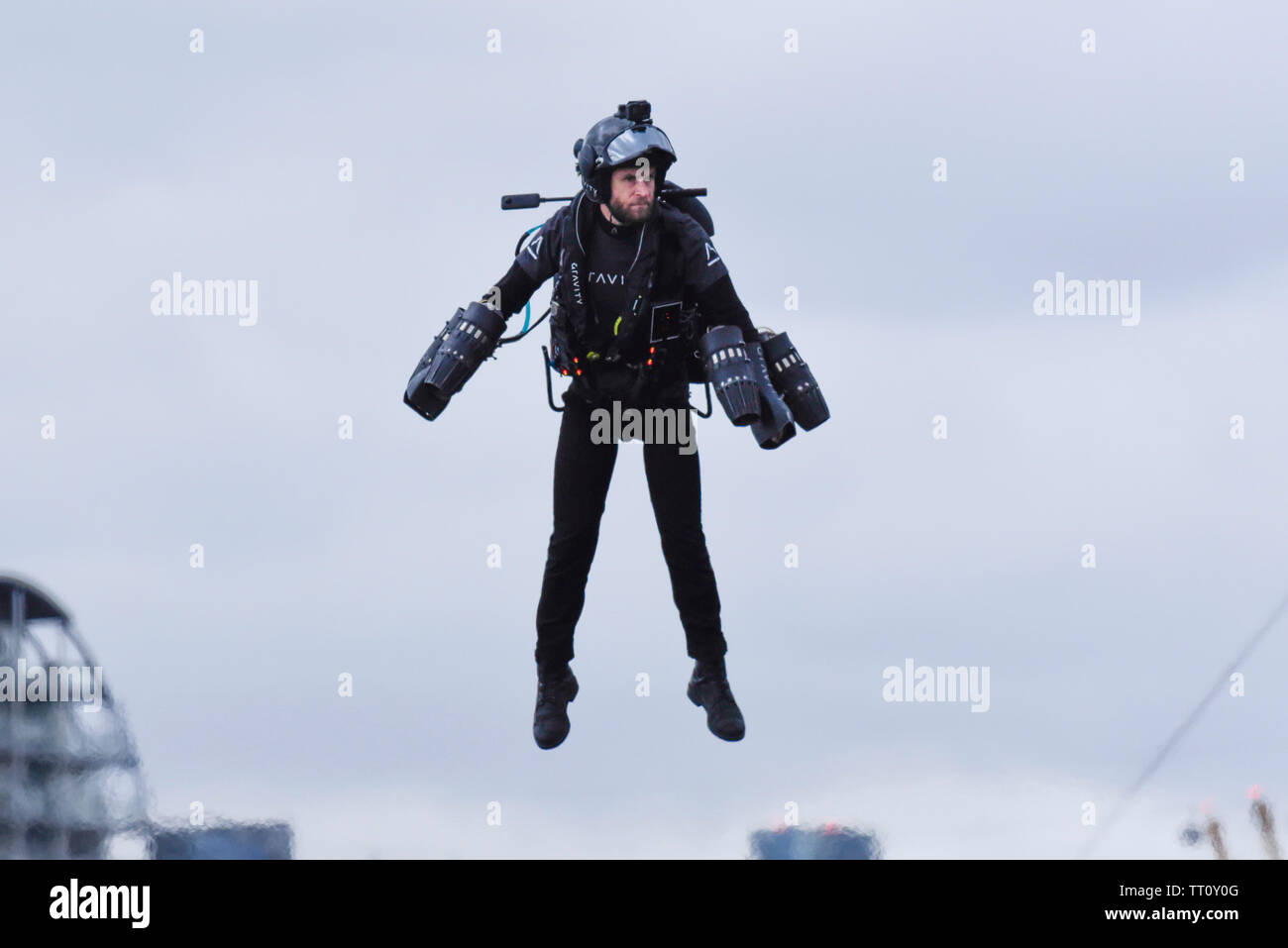 London, UK.  13 June 2019.  Richard Browning the Founder and Chief Test Pilot of Gravity Industries and ‘real life Iron Man’ in the air to preview their Race Series concept at Royal Victoria Docks, East London, during London Tech Week 2019, ahead of the launch of Gravity Industries’ International Race Series in early 2020.  Gravity Industries are the designers, builders and pilots of the world’s first patented Jet Suit, pioneering a new era of human flight. Credit: Stephen Chung / Alamy Live News Stock Photo