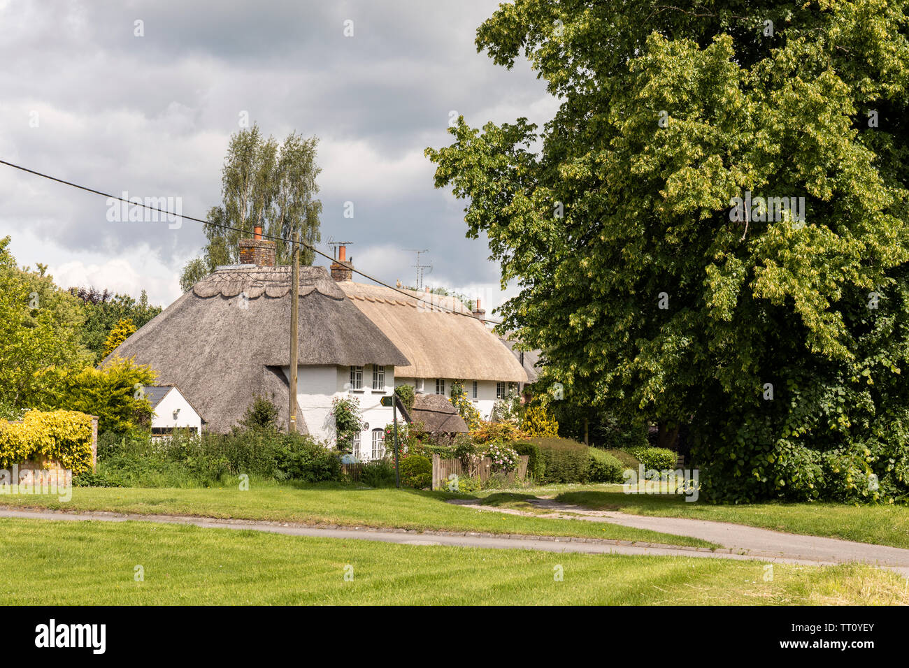 Pretty thatched cottages in the village of East Grafton, Wiltshire, England, UK Stock Photo