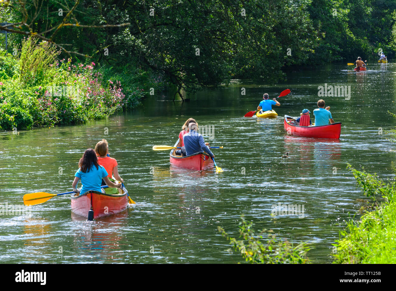 Group of people doing canoe tour on idyllic river in franconia Stock Photo