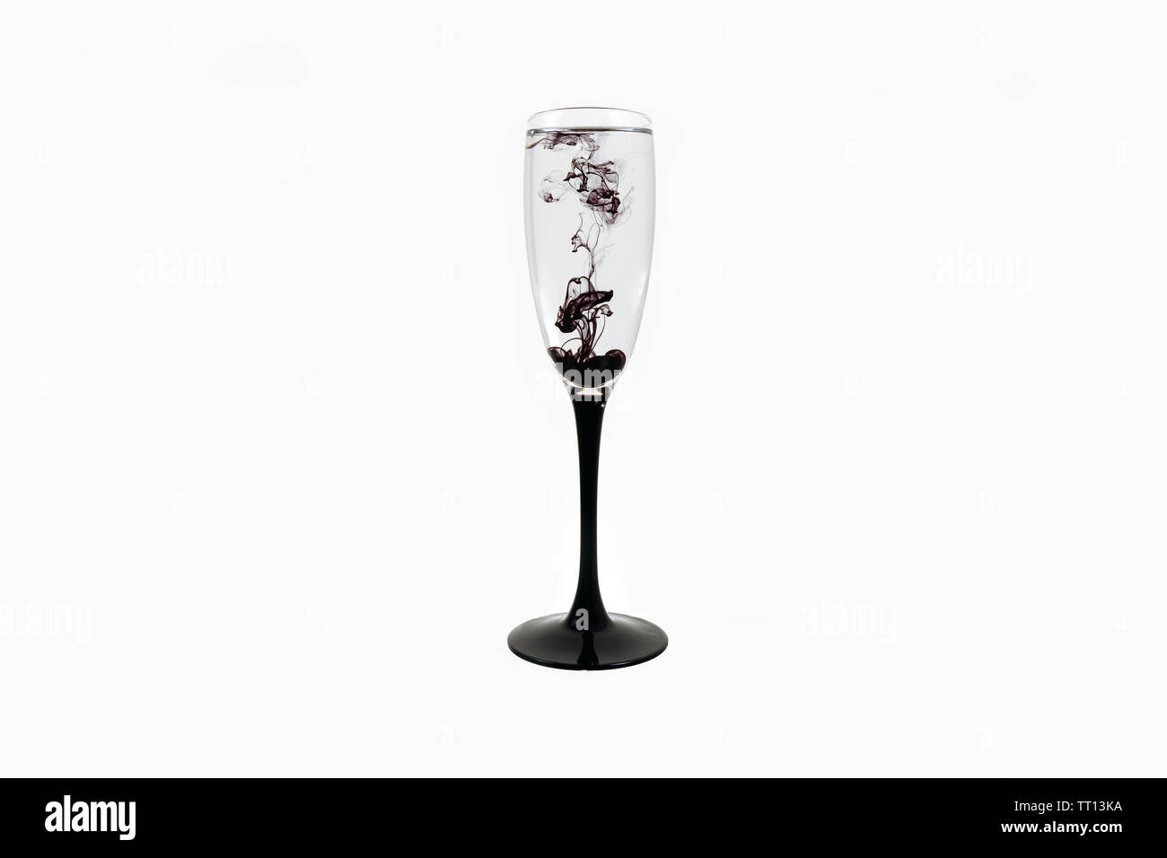 Wine glass on white background with black color paints inside. Fougere