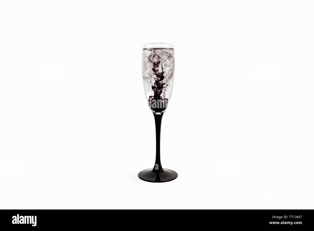 Wine glass on white background with black color paints inside. Fougere