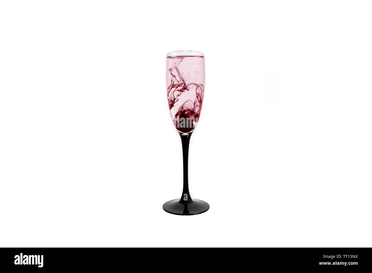 Wine glass on white background with red color paints inside. Fougere