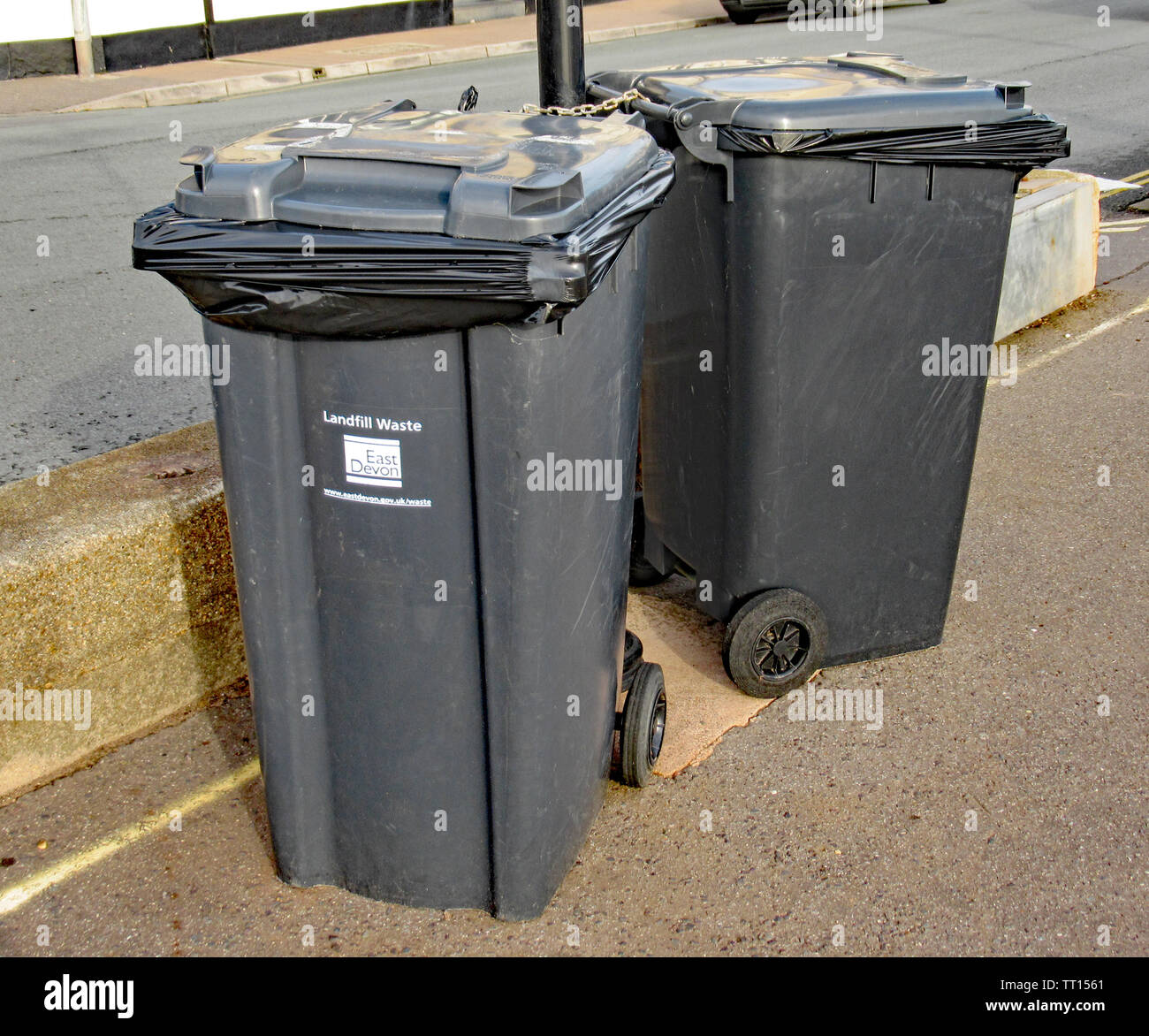 Two refuse bins padlocked to a lamppost on the Esplanade in Sidmouth