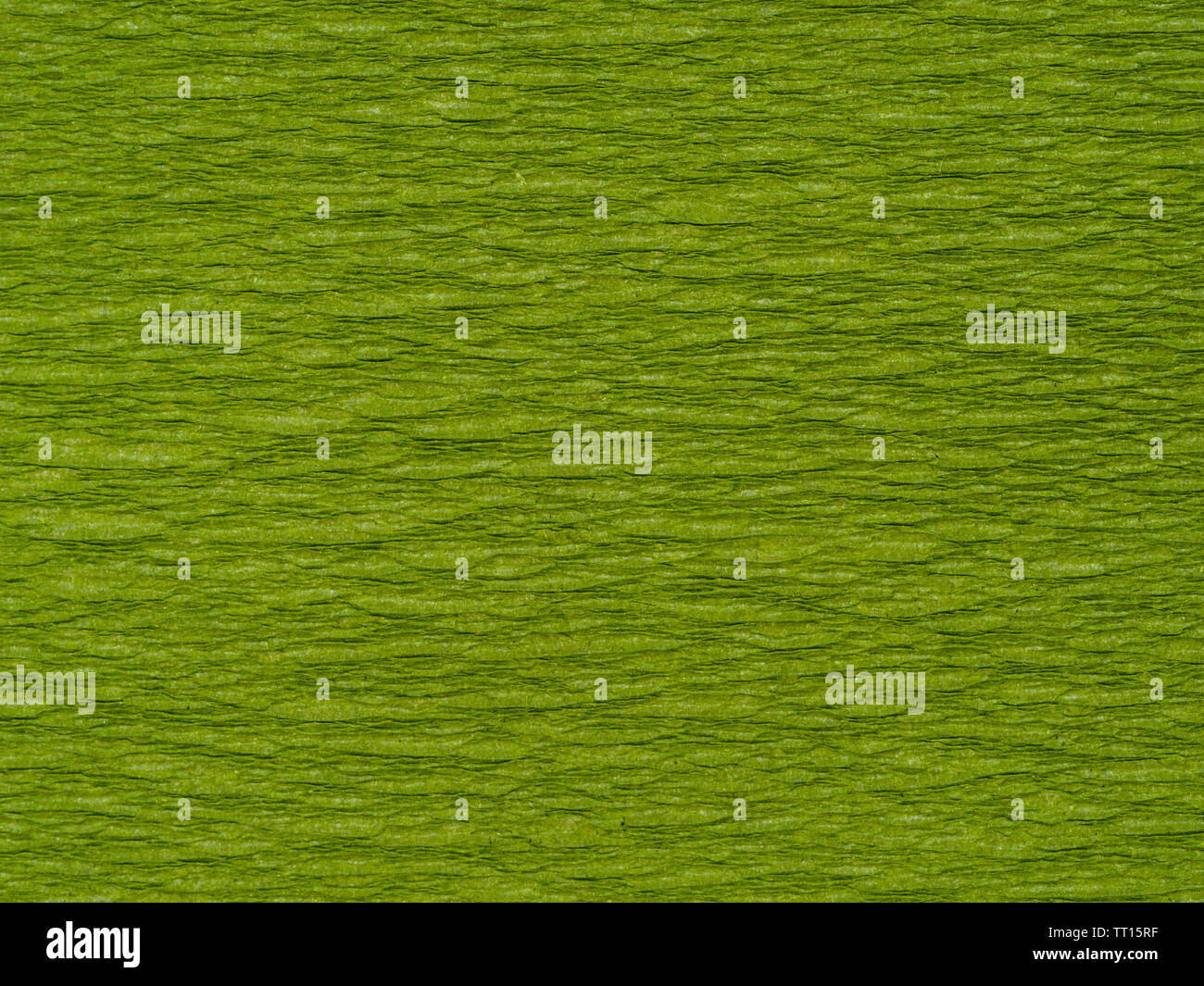 background from dark green chartreuse color corrugated paper close up Stock Photo