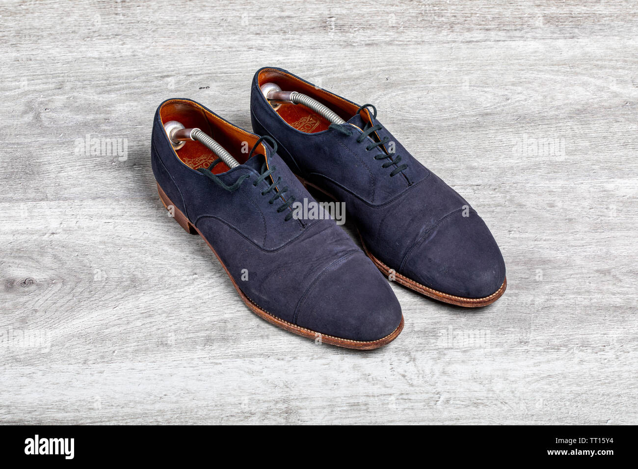 Blue suede shoes with shoe trees in Stock Photo