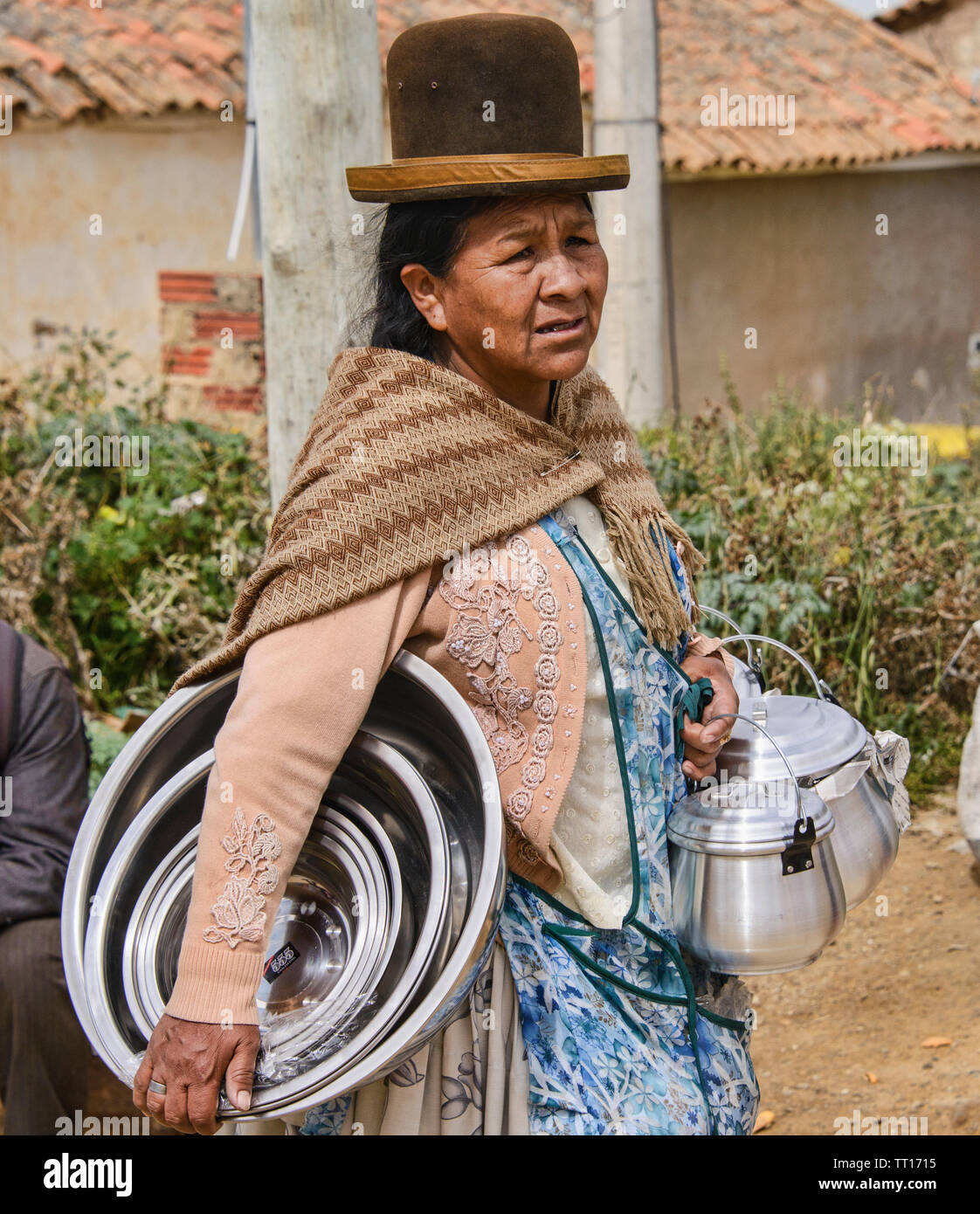 Cholita selling kitchenware at the Sunday Market, Tarabuco, Bolivia Stock Photo