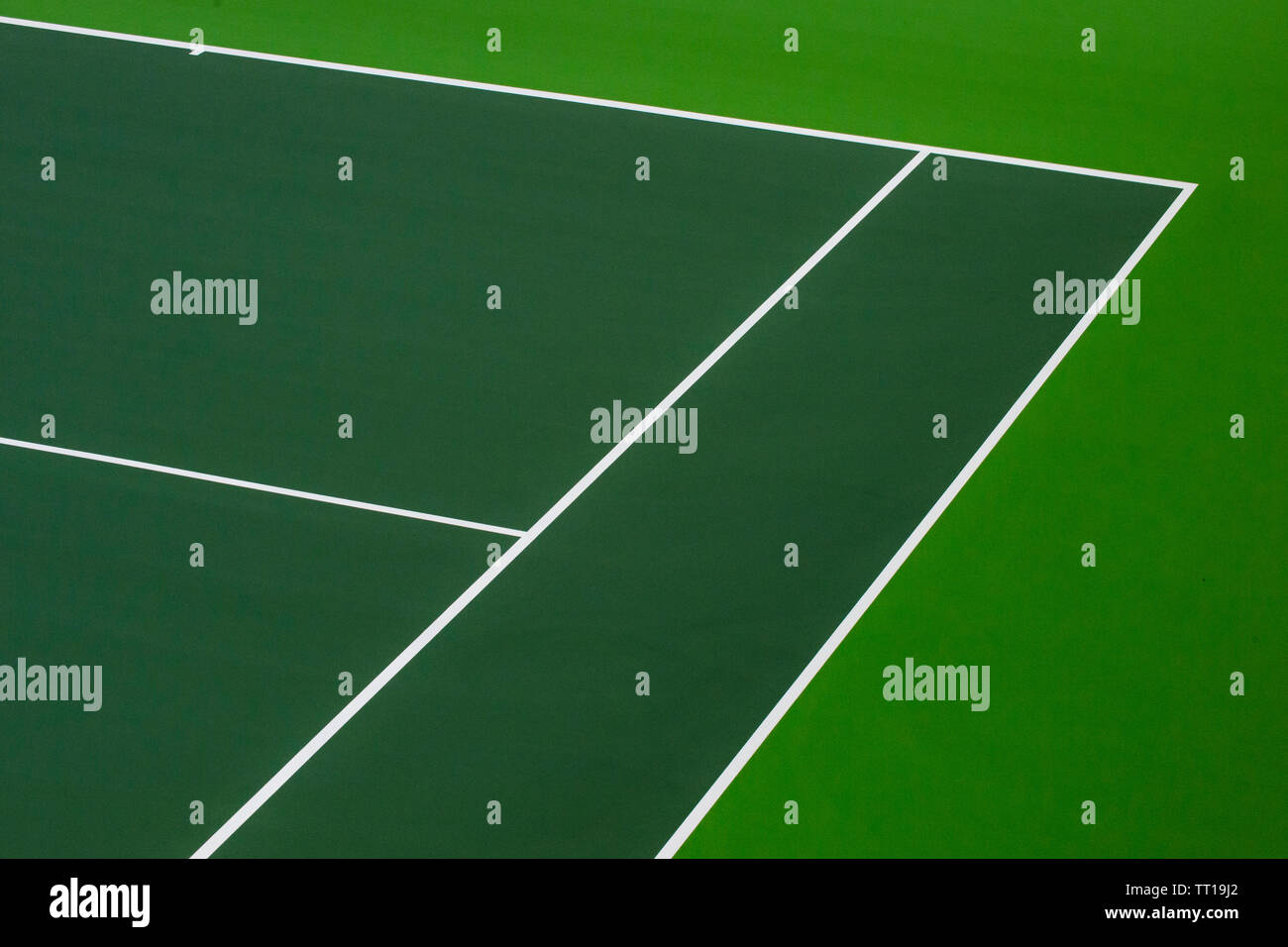 White lines of tennis courts on green floor background and have copy