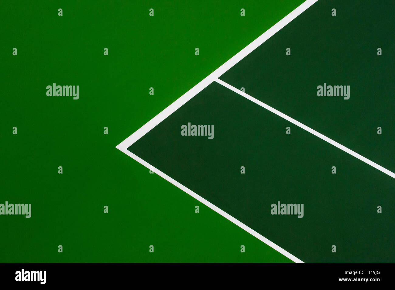 White lines of tennis courts on green floor background and have copy