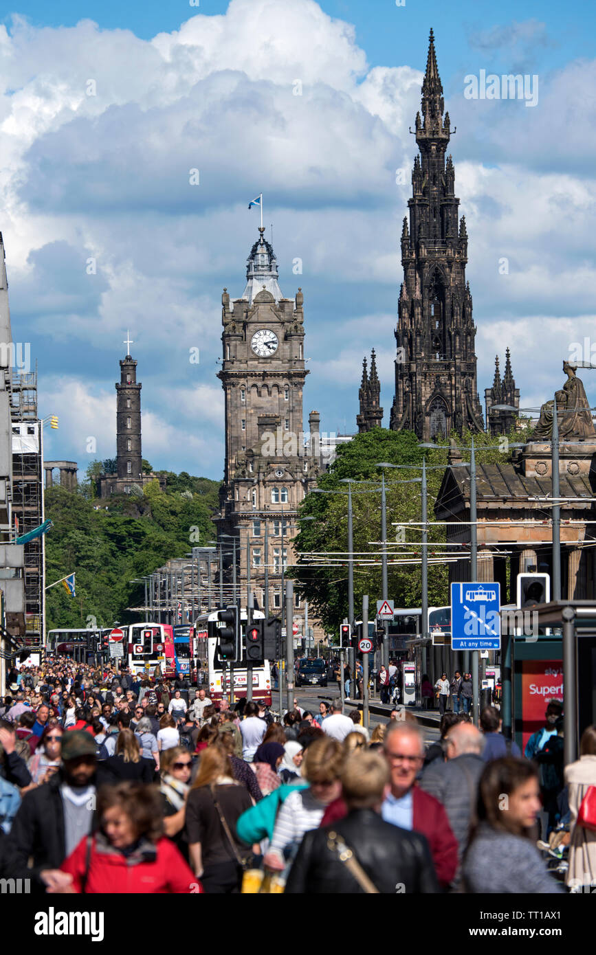 Looking along a busy Princes Street, Edinburgh, Scotland, UK. with the Scott Monument, Balmoral Hotel and Nelson's Monument in the background. Stock Photo