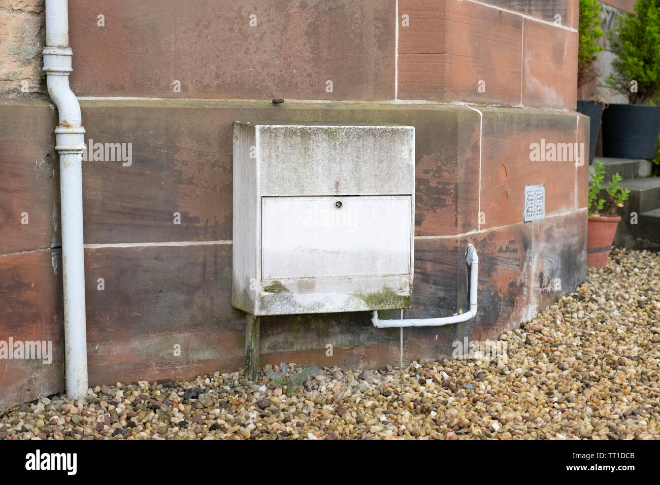 A weathered exterior UK gas meter box closed , Edinburgh, Scotland Stock Photo