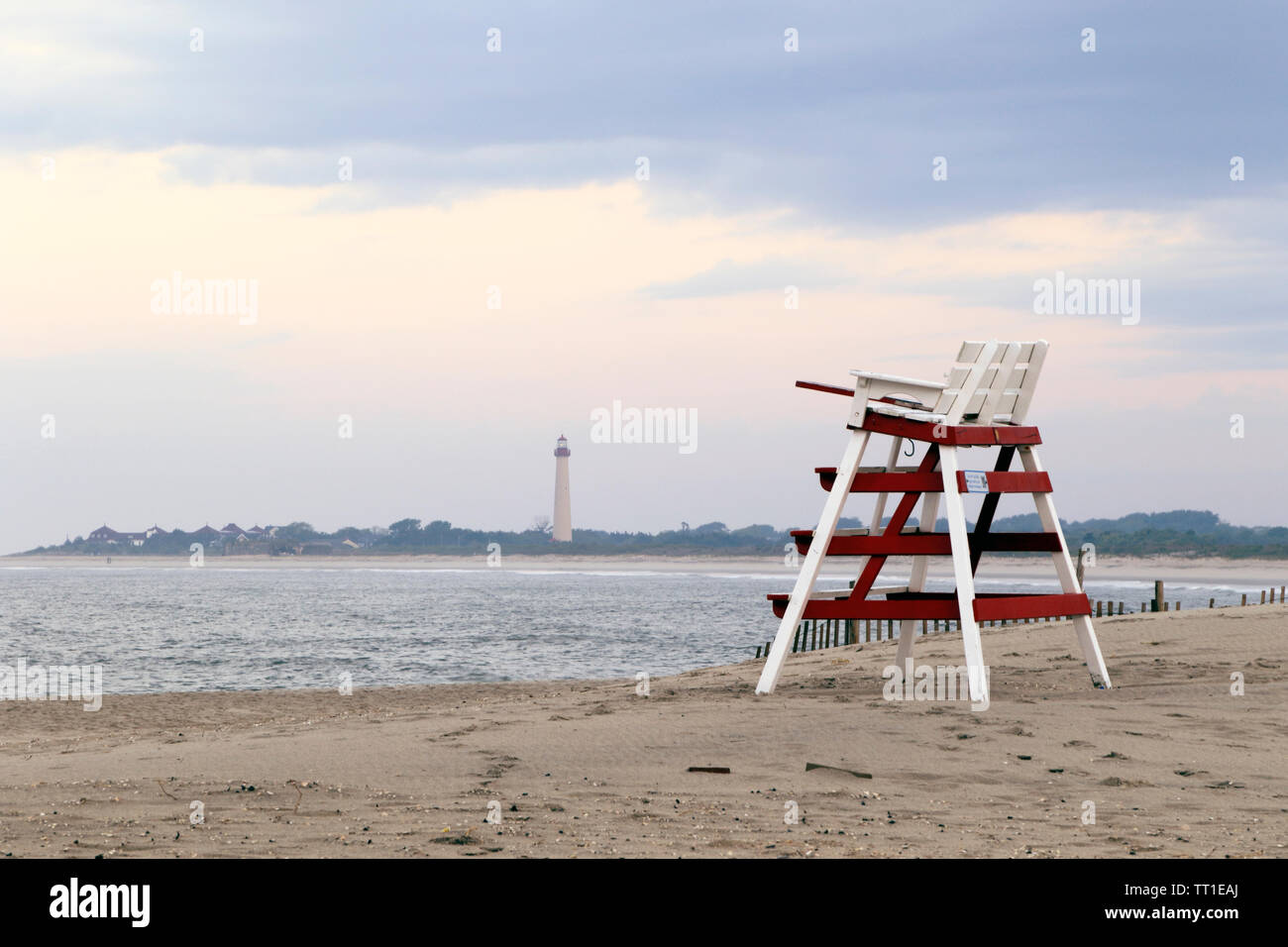 A lifeguard's chair on the beach with the Cape May Lighthouse in the background, Cape May, New Jersey, USA Stock Photo
