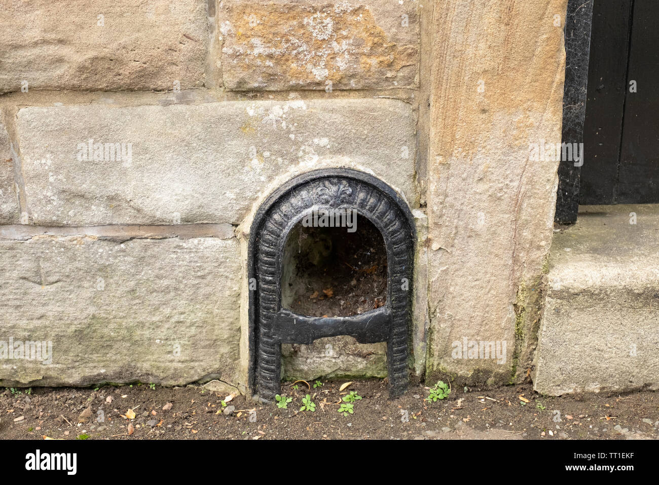 Traditional old boot scraper set in outside wall on street in the Victorian suburb of  Morningside, Edinburgh, Scotland, UK. Stock Photo