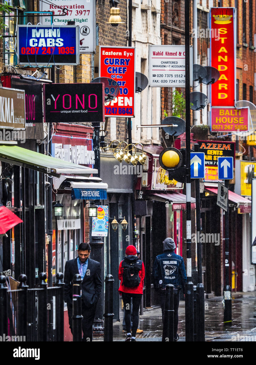 Brick Lane shops and restaurants - Brick Lane is a vibrant restaurant, nightclub and shopping street in the Shoreditch area of East London. Stock Photo