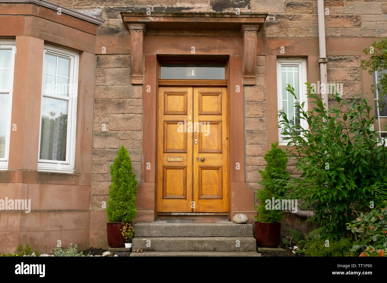 Traditional wooden front door in old stone house, in the Victorian