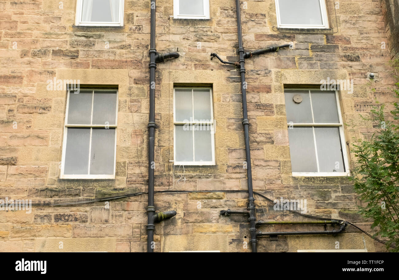 Drainpipes and windows outside old tenement building,  in  the Victorian suburb of Morningside, Edinburgh, Scotland, UK Stock Photo