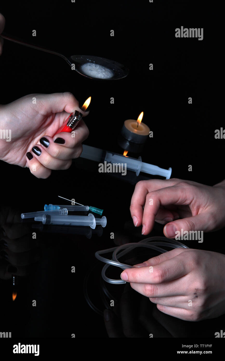 Drug addicts with syringe on black background Stock Photo Alamy
