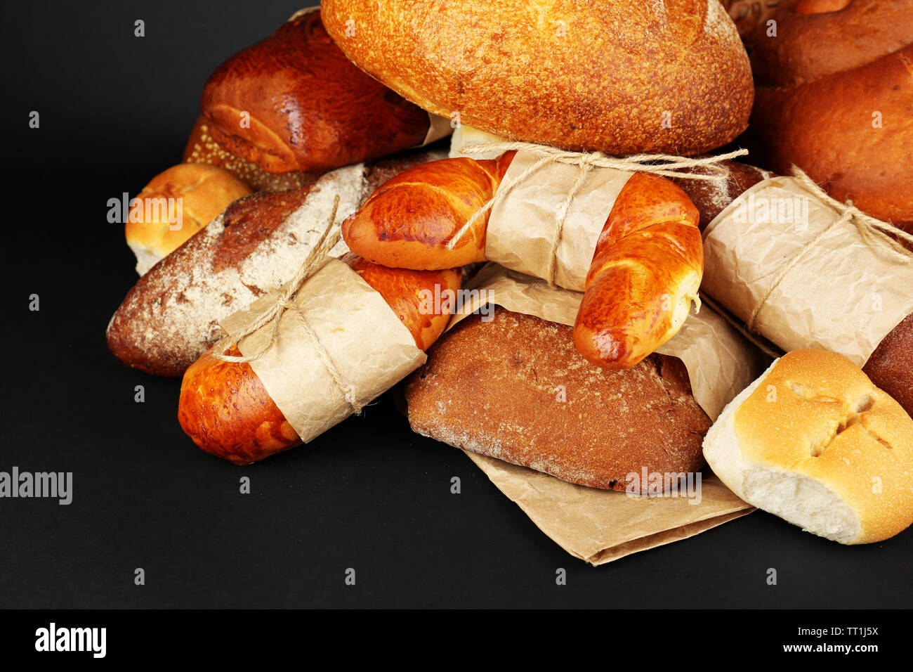 Different types of bread on black background, close-up Stock Photo - Alamy