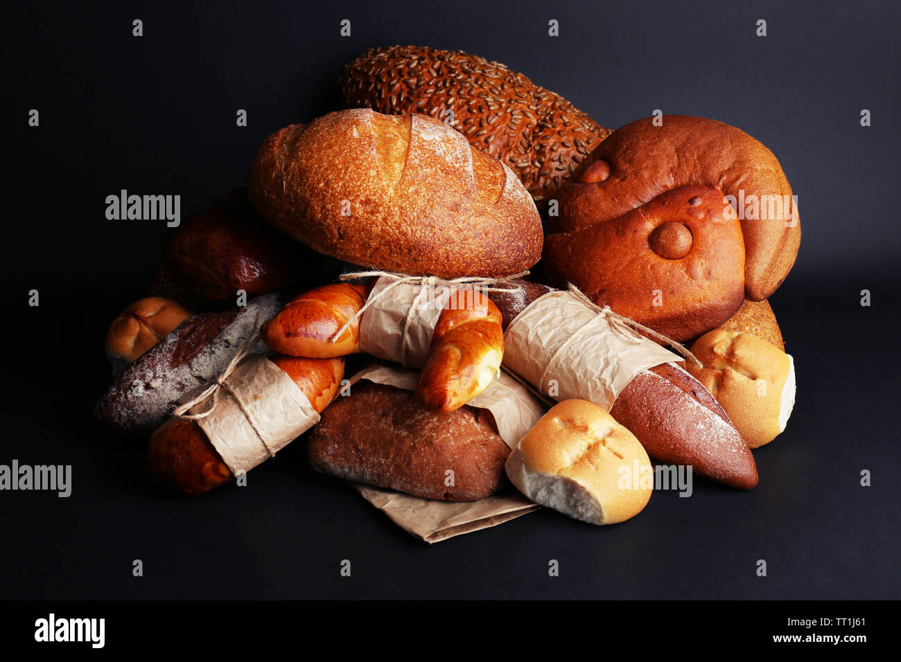 Different types of bread on black background, close-up Stock Photo - Alamy