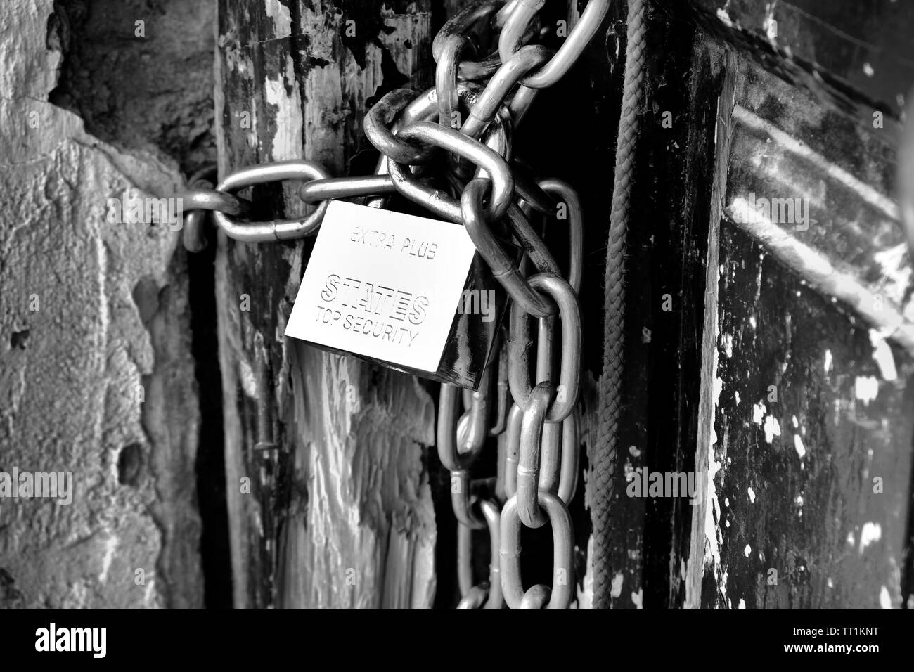 A Chain And Lock On A Black Surface Stock Photo, Picture and