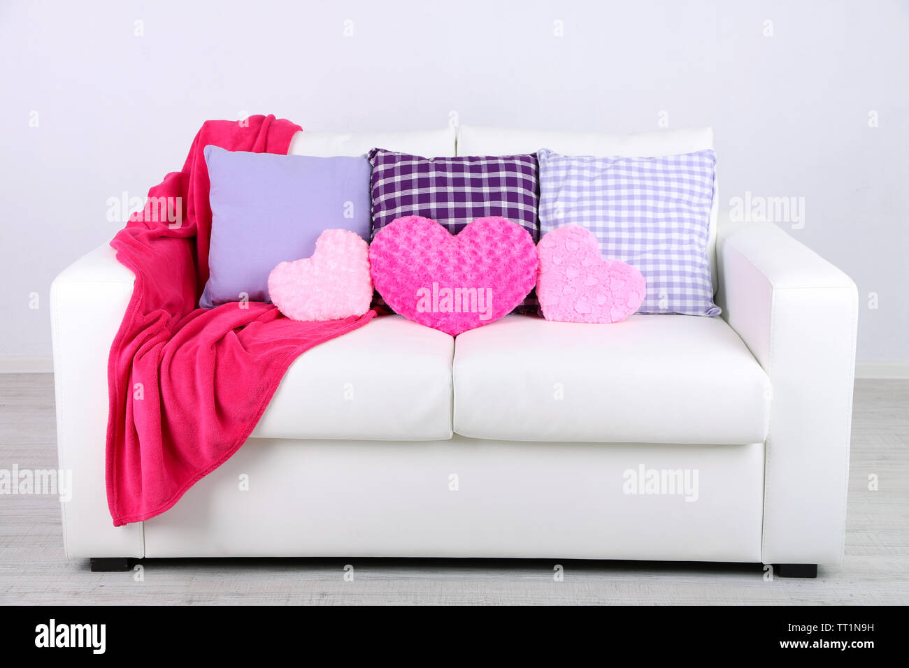 Pink Heart Shaped Pillows Plaid On White Sofa Stock Photo