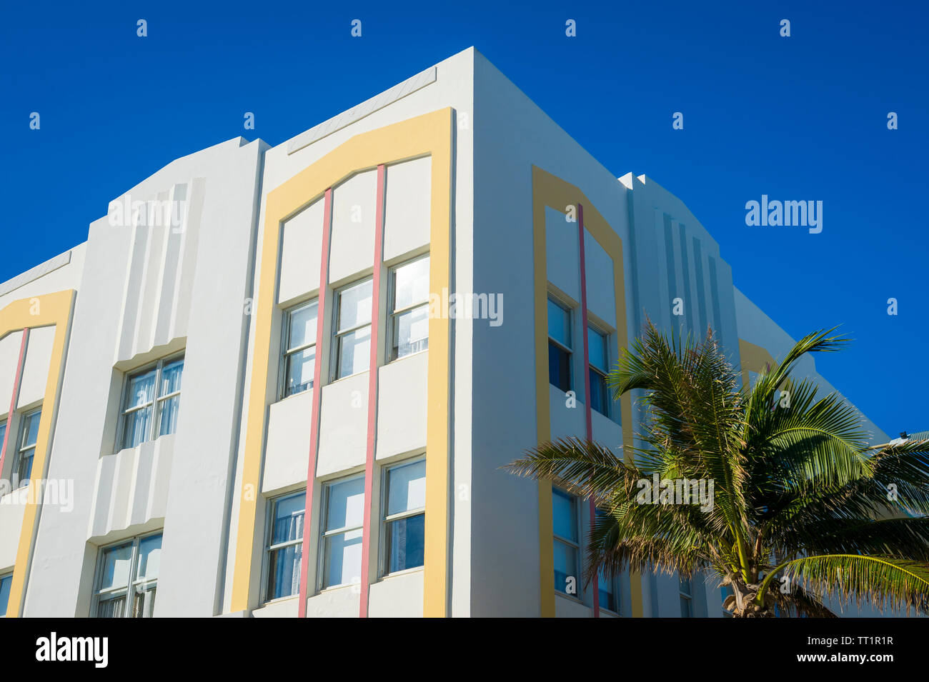 Detail close-up of typical colorful Art Deco architecture with tropical palm tree on Ocean Drive in South Beach, Miami, Florida Stock Photo