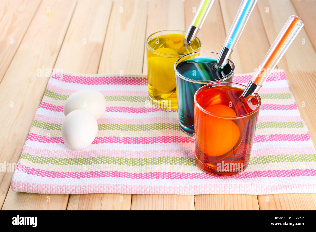 Glasses with paint for Easter eggs and eggs, close up Stock Photo