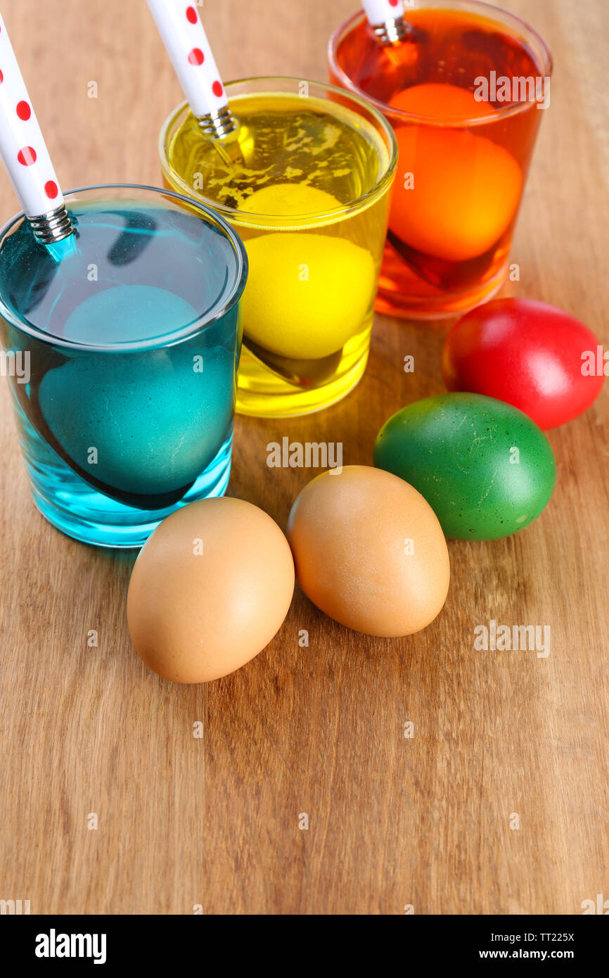 Glasses with paint for Easter eggs and eggs, close up Stock Photo