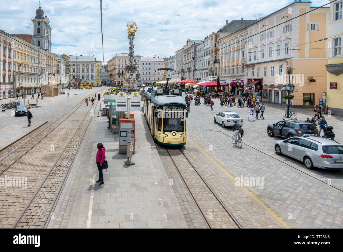 LInz Main Square Hauptplatz with Tram to Pöstlingberg and Plague Column Pestsäule or Dreifaltigkeitssäule Holy Trinity Column Linz Austria Stock Photo