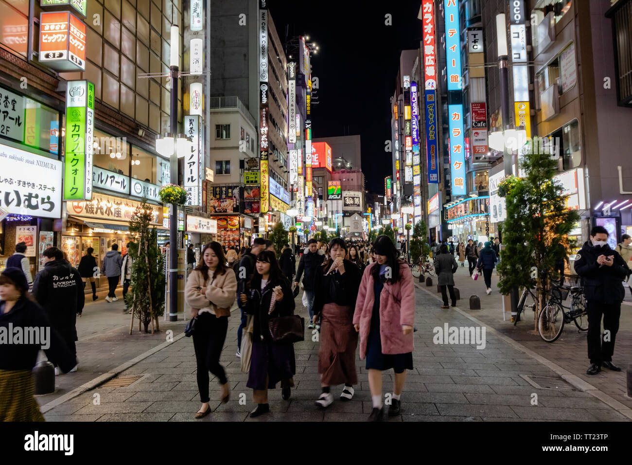 Streets of Shinjuku are buzzing with life. The whole area at night is a colorful visual feast! Stock Photo