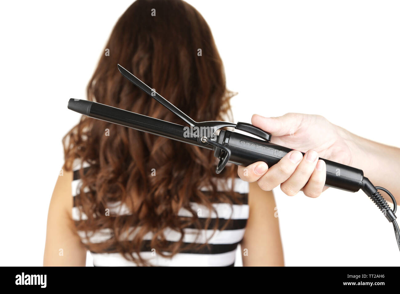 Stylist Using Curling Iron For Hair Curls Close Up Isolated On