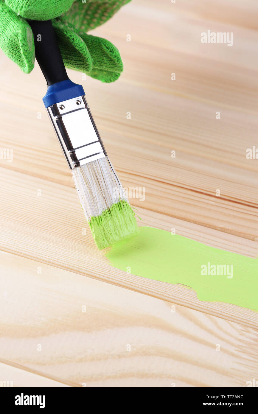 Brush painting wooden furniture, close up Stock Photo Alamy