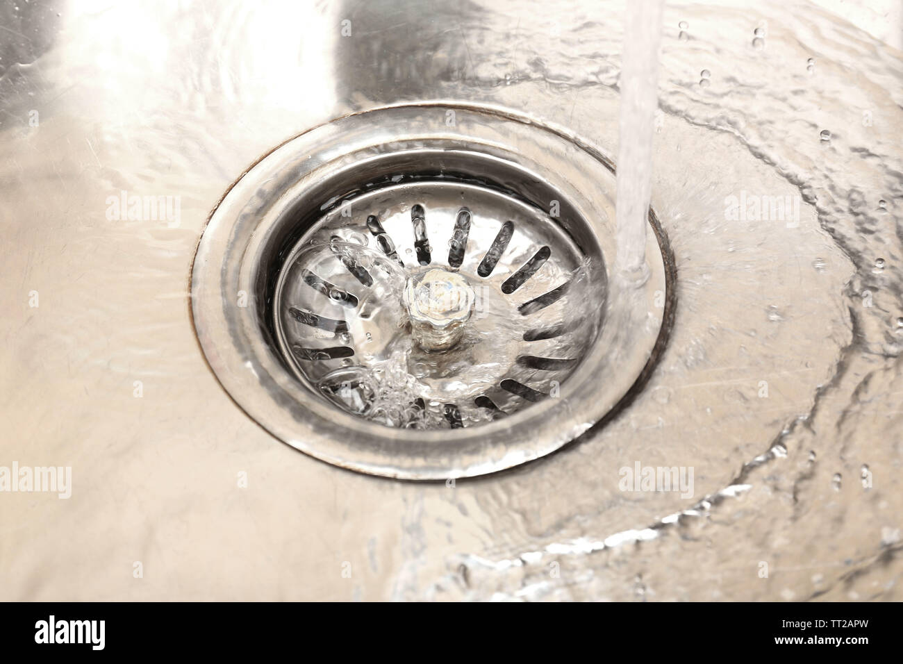 Water flowing down hole in kitchen sink Stock Photo Alamy