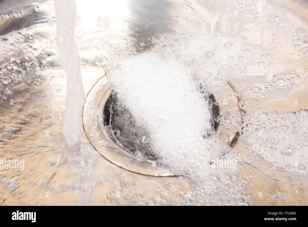 Water flowing down hole in kitchen sink Stock Photo Alamy