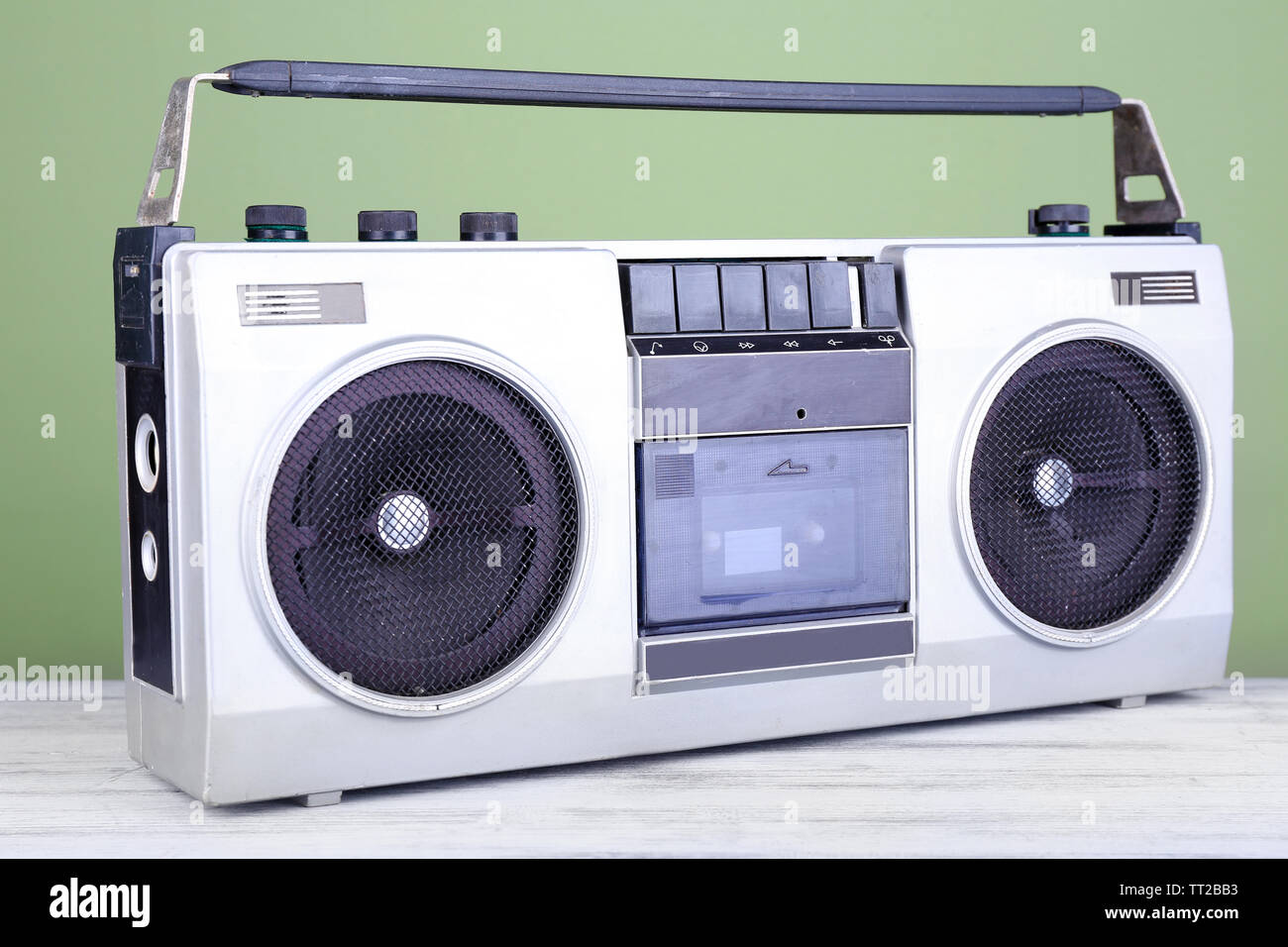 Retro cassette stereo recorder on table on green background Stock Photo