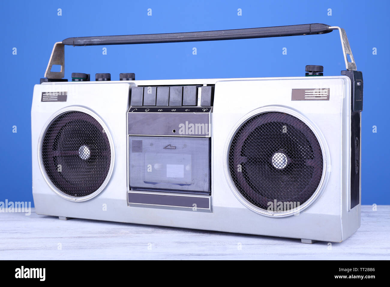 Retro cassette stereo recorder on table on blue background Stock Photo