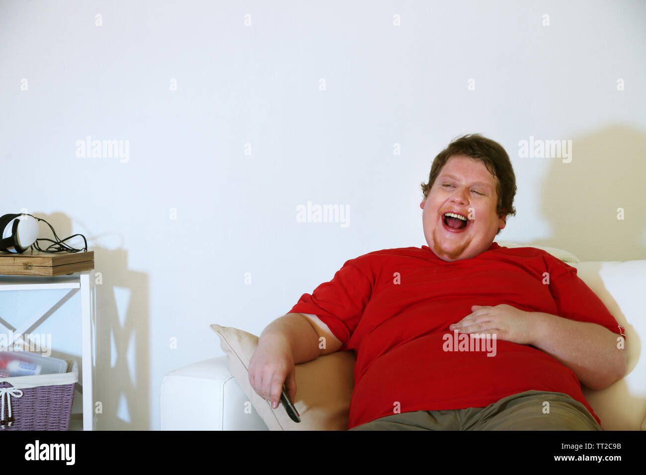 Lazy Overweight Male Sitting On Couch And Watching Television
