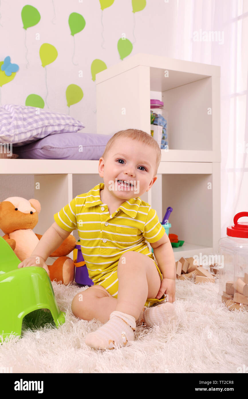 Cute little boy with toys in room Stock Photo - Alamy
