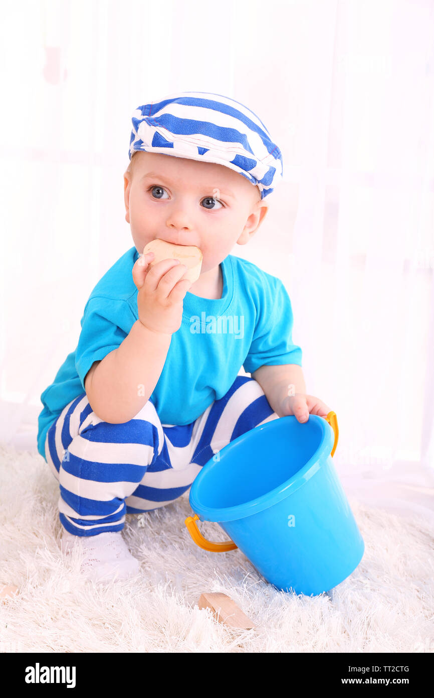 Cute little boy with wooden toy blocks in room Stock Photo - Alamy