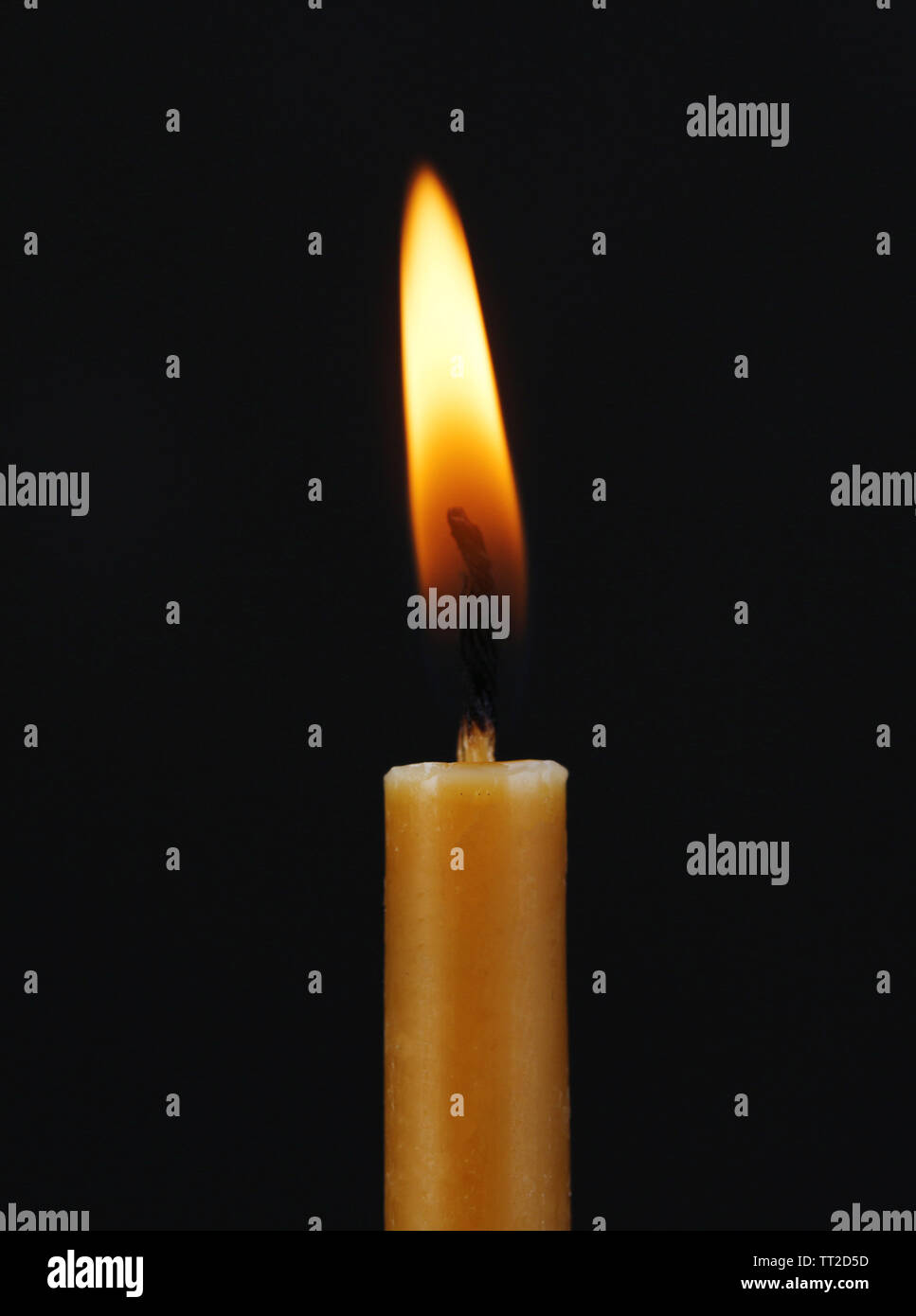 Burning candle on black background Stock Photo
