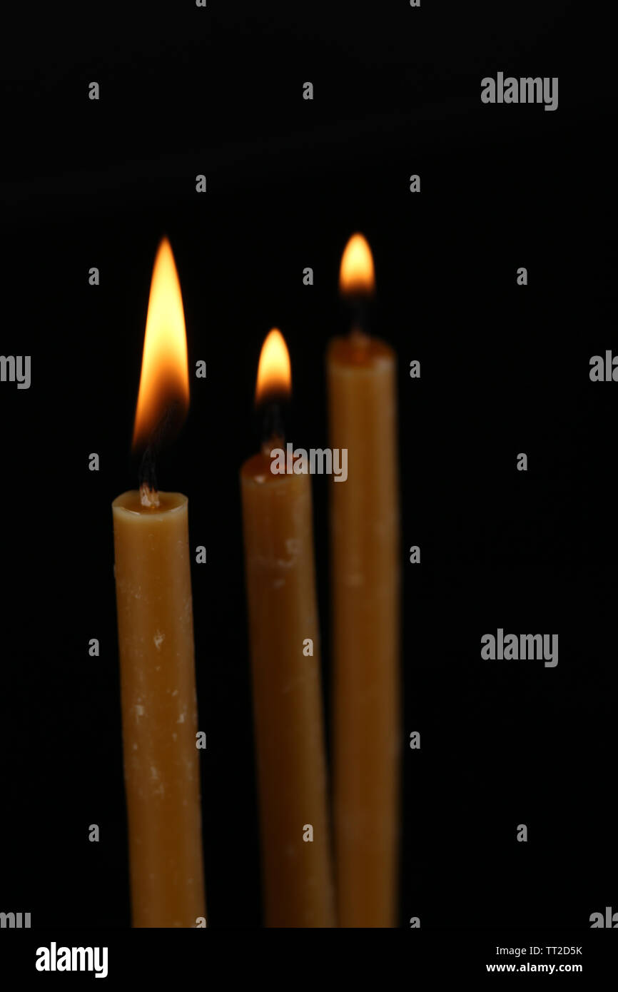 Burning candles on black background Stock Photo - Alamy