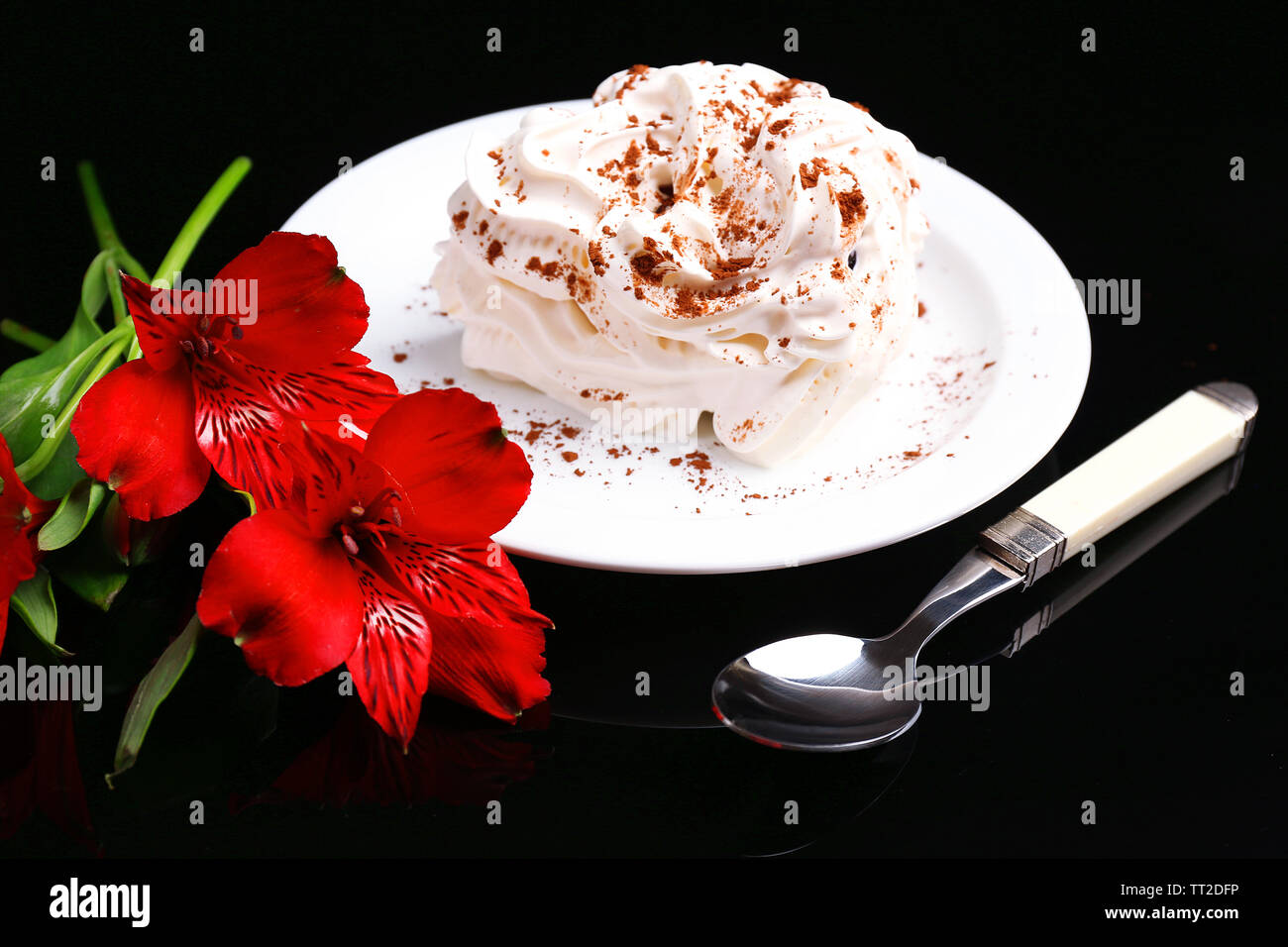 Tasty cake with cream, on black background Stock Photo - Alamy