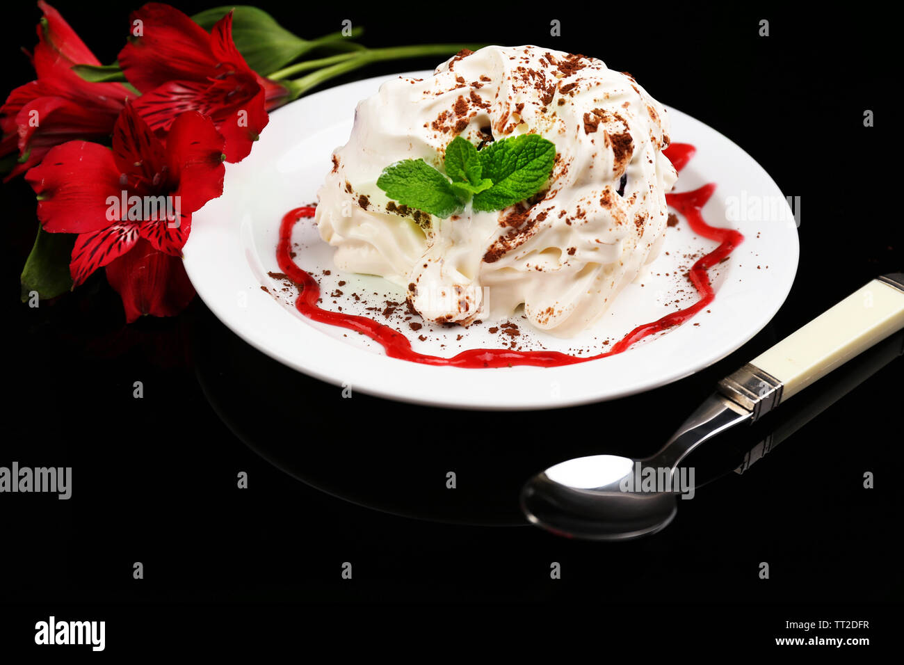 Tasty cake with cream, on black background Stock Photo - Alamy