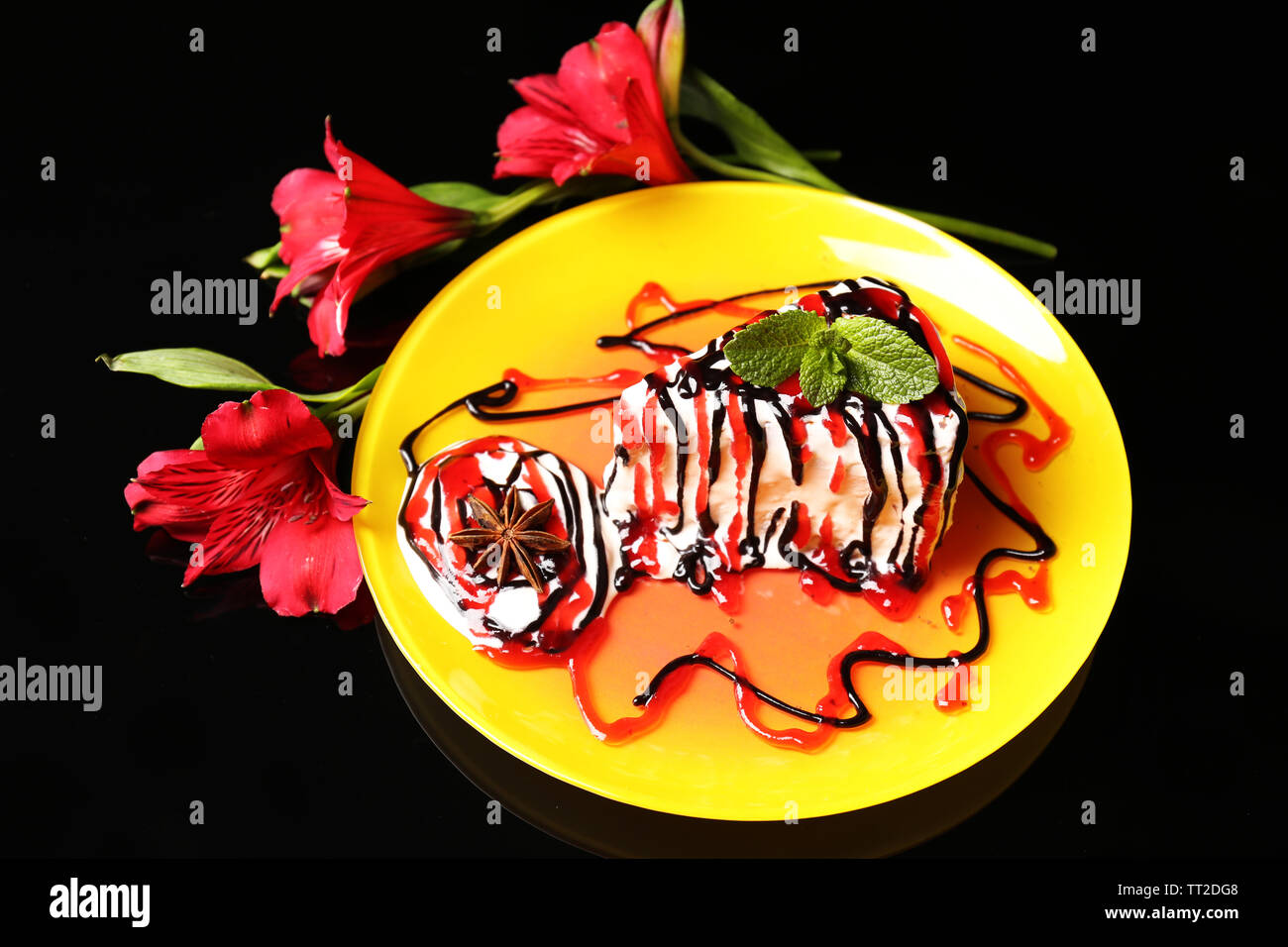 Tasty cake with cream, on black background Stock Photo - Alamy