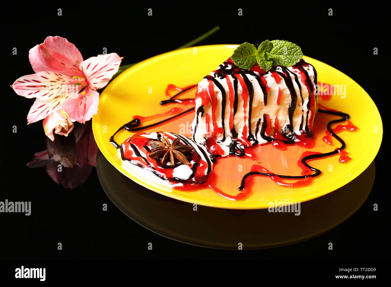 Tasty cake with cream, on black background Stock Photo - Alamy