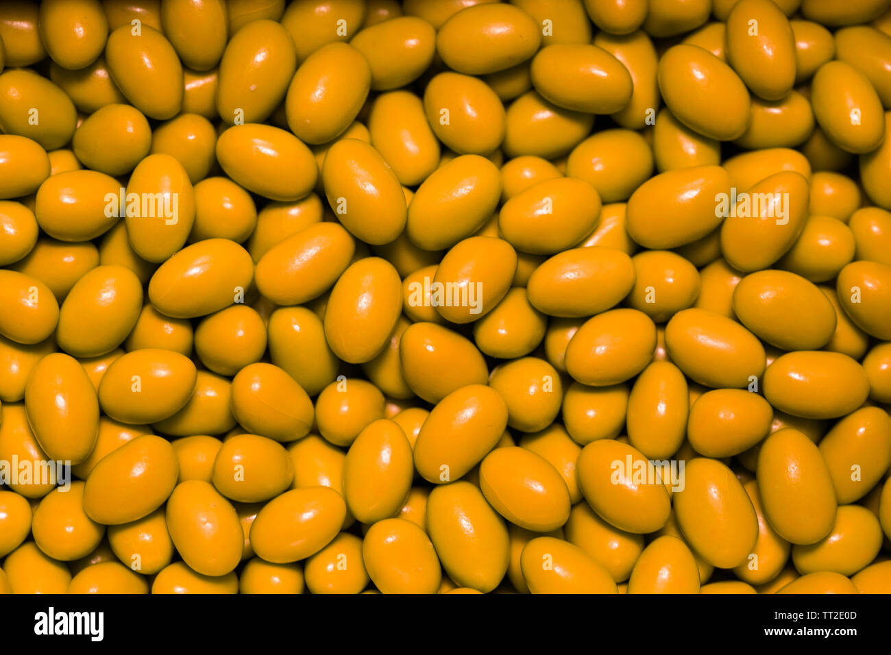 yellow candies sugar coated chocolates Stock Photo Alamy