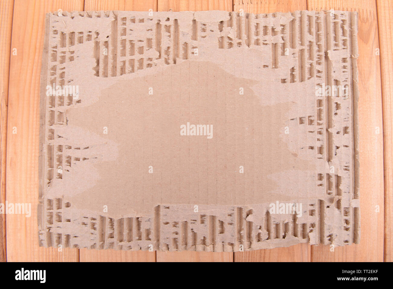 Cardboard on wooden background Stock Photo - Alamy
