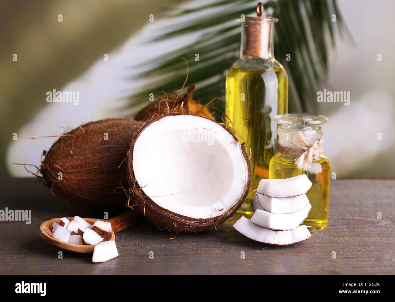 Coconuts and coconut oil on wooden table Stock Photo Alamy